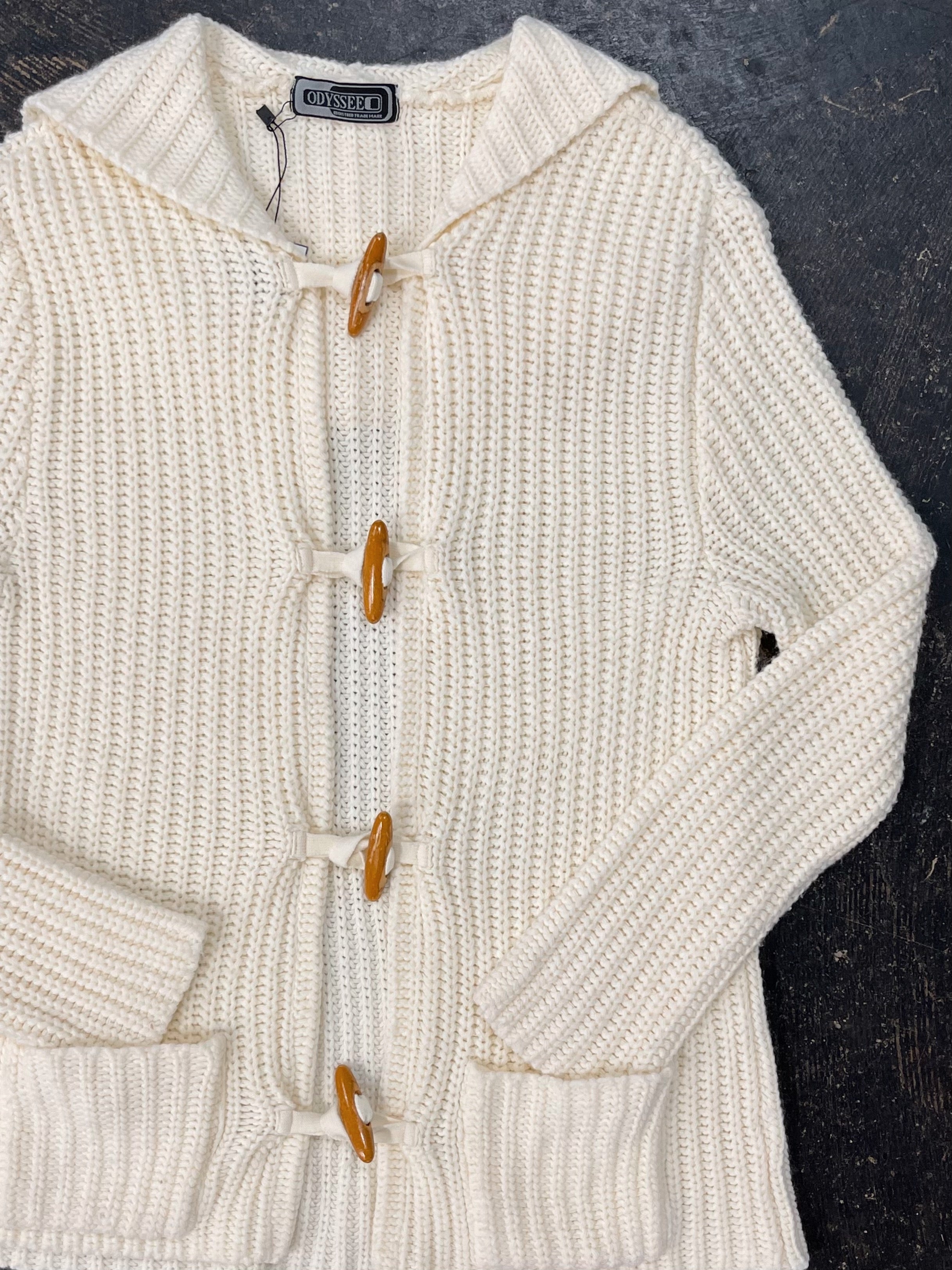 Sweater with outlet toggle buttons